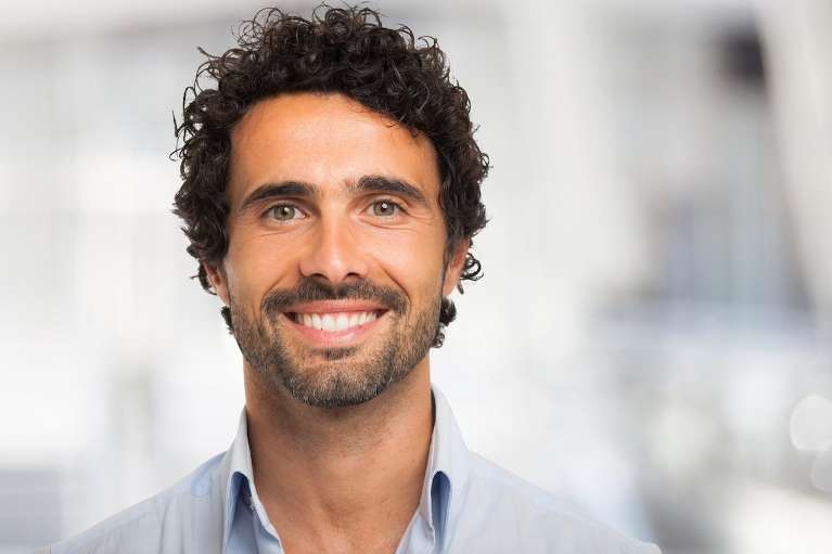 A man smiling after Getting Porcelain Veneers in Tampa, FL